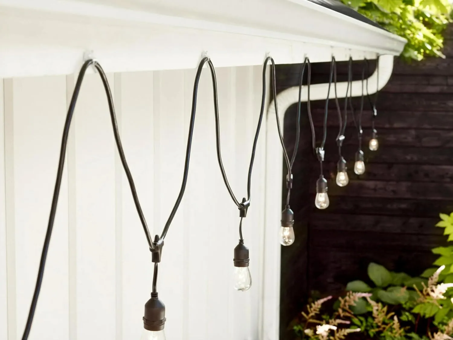 Command Outdoor Light Clips, 4 Pack of 16 Clear Clips and 20 Command Strips, Damage Free Hanging Light Clips with Adhesive Strips, Wall Clips for Hanging Outdoor Lights and Cables Outside